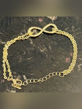 Gold Tone Infinity Bracelet. Never worn.